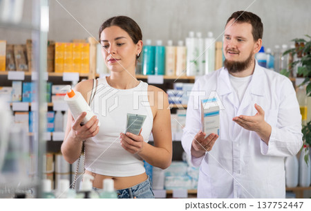 Woman choosing cream with help from pharmacist Woman choosing cream with help from pharmacist 137752447