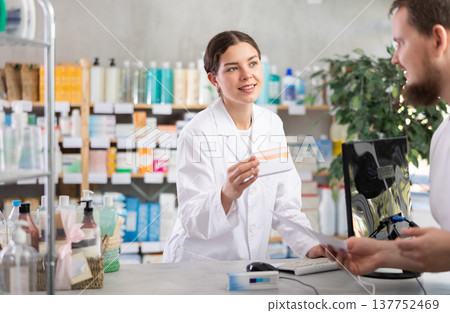 Female pharmacist gives man prescription pills Female pharmacist gives man prescription pills 137752469