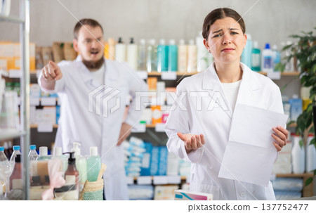 Confused girl pharmacist employee during argument with boss 137752477