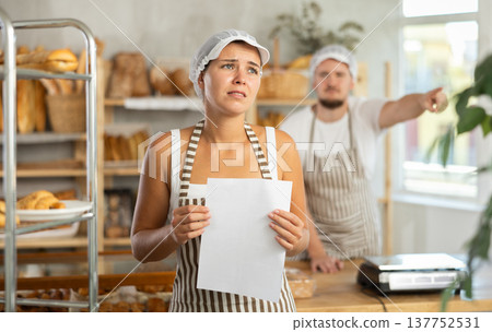 Young girl stands with her back to angry man pointing at the door 137752531