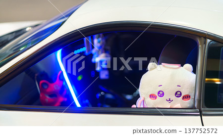 Tokyo, Japan - Sep 30 2024, close-up view of the passenger car interior through the window, in which sits a large plush toy, at the Shibuya Crossing, without people, Tokyo, Japan Tokyo, Japan - Sep 30 2024, close-up view of the passenger car interior through the window, in which sits a large plush toy, at the Shibuya Crossing, without people, Tokyo, Japan 137752572