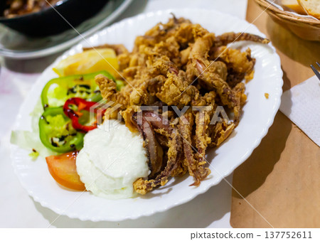 Appetizing dish of grilled squid legs in batter 137752611