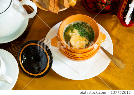 Fish soup with herbs in a pot. Fish soup with herbs in a pot. 137752612