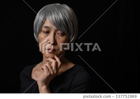A white-haired senior woman plotting something evil A white-haired senior woman plotting something evil 137752869