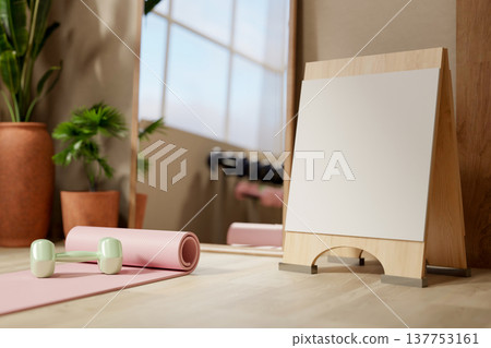 Yoga mat and dumbbell with blank signboard on wooden floor aside mirror in fitness gym exercise room Yoga mat and dumbbell with blank signboard on wooden floor aside mirror in fitness gym exercise room 137753161