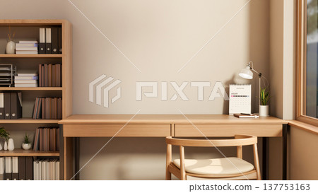 Calendar and lamp with plant pot on wooden table and chair aside bookshelf and window in room corner 137753163