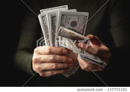 Hands counting US dollar banknote, symbolizing finance, payment, banking 137753182