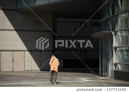 A senior woman walking to the Nagoya Arts Center on a winter afternoon. A senior woman walking to the Nagoya Arts Center on a winter afternoon. 137753580