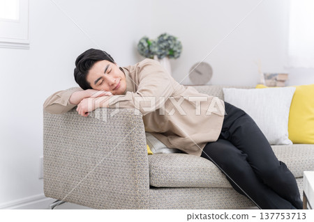 A man sleeping on the sofa A man sleeping on the sofa 137753713