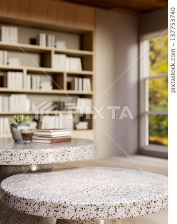 Black and white round marble stone tables across wooden bookshelf and window in modern living room. 137753740