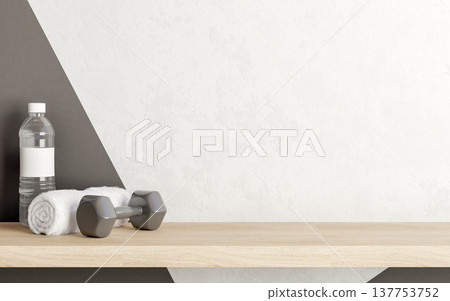 Dumbbell with towel and water bottle on wooden hanging floating shelf in white and grey wall room. Dumbbell with towel and water bottle on wooden hanging floating shelf in white and grey wall room. 137753752