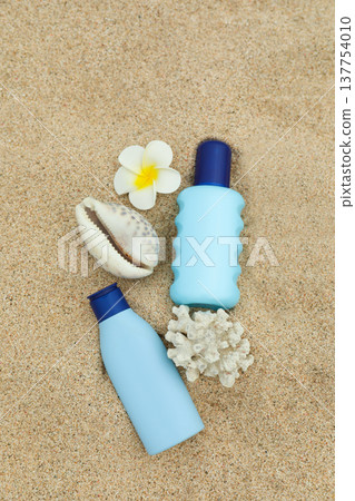 Sunscreen bottles and shell on sand at Bali beach Sunscreen bottles and shell on sand at Bali beach 137754010