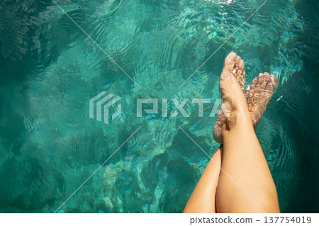Feet dangle in clear water on a sunny day in Bali Feet dangle in clear water on a sunny day in Bali 137754019