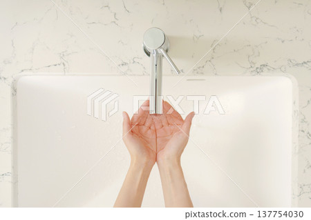 Close-up of a woman washing her hands, overhead shot Close-up of a woman washing her hands, overhead shot 137754030