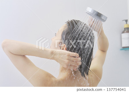 Woman rinsing her hair in the shower 137754041