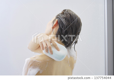 Woman washing body in the bathroom 137754044
