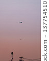 A helicopter and a telephone pole flying in the sunset sky. A helicopter and a telephone pole flying in the sunset sky. 137754510