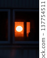 The sunset and orange sky visible from the window The sunset and orange sky visible from the window 137754511