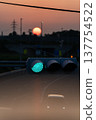Sunset and transmission towers visible from a pedestrian overpass in the city. Sunset and transmission towers visible from a pedestrian overpass in the city. 137754522