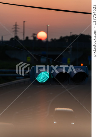 Sunset and transmission towers visible from a pedestrian overpass in the city. Sunset and transmission towers visible from a pedestrian overpass in the city. 137754522