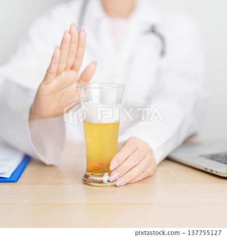 Doctor hand stop to refuse Beer, quitting drink for healthy liver, prevent Alcoholic cirrhosis and cancer, World No Alcohol Day, medical advice for sobriety and Alcoholism and addiction concept Doctor hand stop to refuse Beer, quitting drink for healthy liver, prevent Alcoholic cirrhosis and cancer, World No Alcohol Day, medical advice for sobriety and Alcoholism and addiction concept 137755127