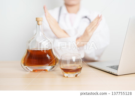 Doctor hand stop to refuse Whisky, quitting drink for healthy liver, prevent Alcoholic cirrhosis and cancer, World No Alcohol Day, medical advice for sobriety and Alcoholism and addiction concept Doctor hand stop to refuse Whisky, quitting drink for healthy liver, prevent Alcoholic cirrhosis and cancer, World No Alcohol Day, medical advice for sobriety and Alcoholism and addiction concept 137755128