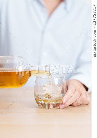man pour whiskey into a glass on table, suffering from alcohol addiction, alcoholism concept. depicting emotional distress, depression, substance abuse problem, unhealthy lifestyle and mental health man pour whiskey into a glass on table, suffering from alcohol addiction, alcoholism concept. depicting emotional distress, depression, substance abuse problem, unhealthy lifestyle and mental health 137755217
