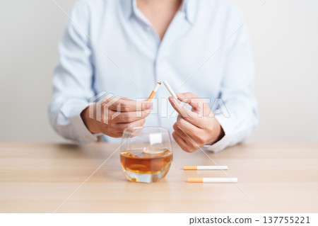 Man hand break and stop gesture to refuse cigarette and glass of Whisky, for say no to alcohol drink and for World No Tobacco Day, quitting smoking to prevent Lung Cancer and stop nicotine addiction 137755221