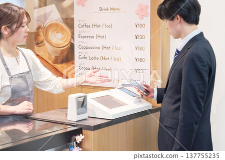 Business people using cashless payments with their smartphones Business people using cashless payments with their smartphones 137755235