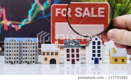 Magnifying Glass over Model Houses and For Sale Sign Magnifying Glass over Model Houses and For Sale Sign 137755892