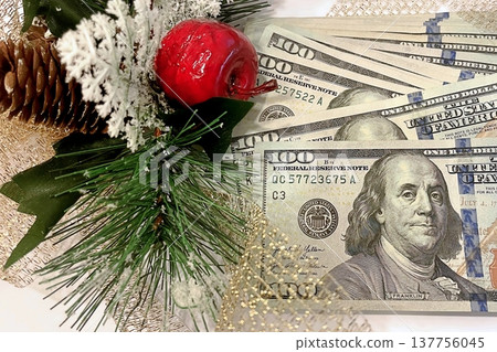 Christmas Cash and Holiday Decorations. $100 dollar bills with festive ornaments. Perfect for holiday budget, bonus, and shopping concepts. 137756045