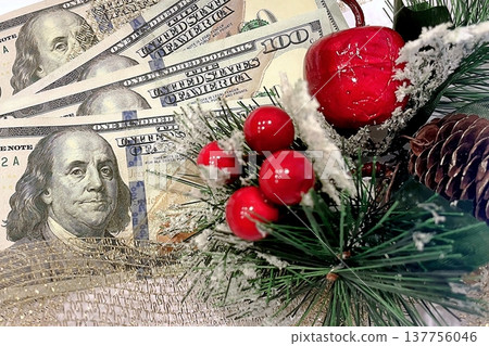 Christmas Cash and Holiday Decorations. $100 dollar bills with festive ornaments. Perfect for holiday budget, bonus, and shopping concepts. 137756046