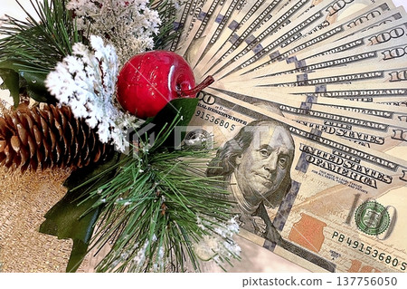 Christmas Cash and Holiday Decorations. $100 dollar bills with festive ornaments. Perfect for holiday budget, bonus, and shopping concepts. 137756050