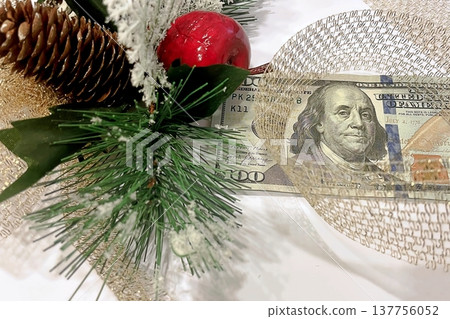 Christmas Cash and Holiday Decorations. $100 dollar bills with festive ornaments. Perfect for holiday budget, bonus, and shopping concepts. 137756052