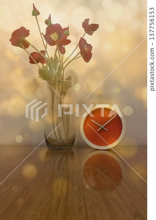 A warm interior with red poppies and an orange clock. A warm, minimalist look featuring flowers and a modern clock against a gold bokeh background. Perfect for lifestyle decor. 137756153