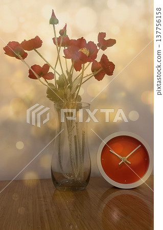 A warm interior with red poppies and an orange clock. A warm, minimalist look featuring flowers and a modern clock against a gold bokeh background. Perfect for lifestyle decor. 137756158