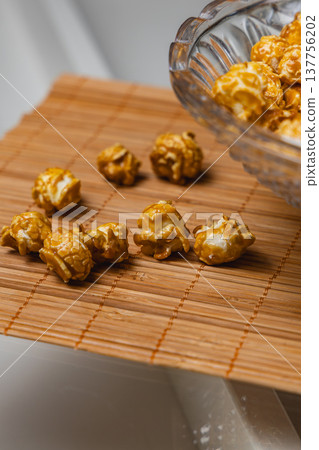 Popcorn on bamboo mat with bowl tilted during snack time 137756202