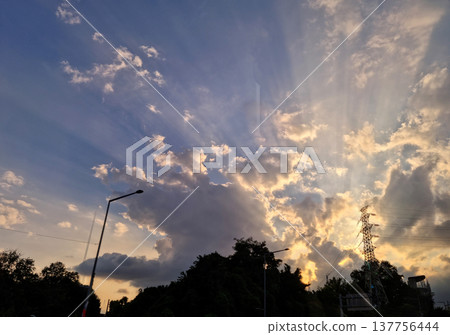 It's a sunset sky with sunlight shining through the clouds. It's a sunset sky with sunlight shining through the clouds. 137756444
