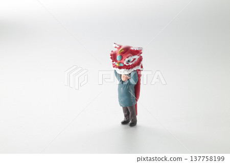 Miniature Performer Lifts Vibrant Red lion Head Upward 137758199