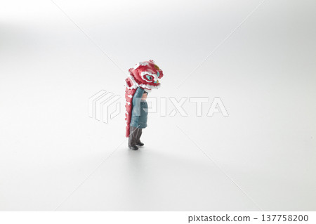 Miniature Performer Lifts Vibrant Red lion Head Upward 137758200