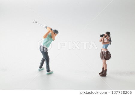 Miniature Golfer Swings Club While Photographer Captures Action 137758206