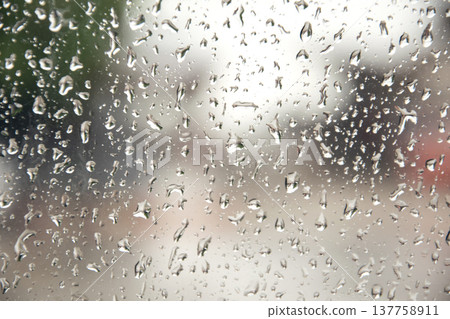 Rain drop on the car glass. Road view through car window with rain drops, Driving in rain. Rain drop on the car glass. Road view through car window with rain drops, Driving in rain. 137758911