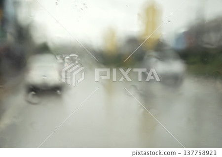 Rain drop on the car glass. Road view through car window with rain drops, Driving in rain. Rain drop on the car glass. Road view through car window with rain drops, Driving in rain. 137758921
