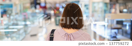 backside of short hair asian woman shopping at mall during sale and discount with wear protective mask 137759272
