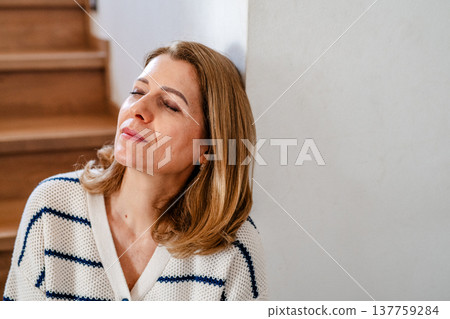 Beautiful woman resting, sitting on stairs. Beautiful woman resting, sitting on stairs. 137759284