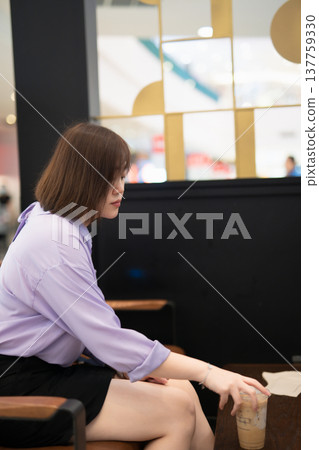 asian business woman drinking coffee at outdoor of coffee shop 137759330