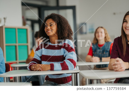 Confident teen students during lesson in modern classroom. 137759384
