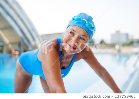 Senior woman getting ready for swim. Senior woman getting ready for swim. 137759465