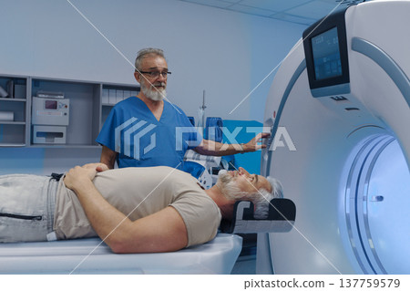 Doctor operationg CT machine in hospital. Doctor operationg CT machine in hospital. 137759579