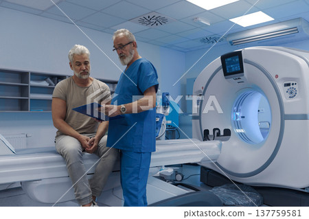 Doctor explaining CT scan results to patient in hospital setting 137759581